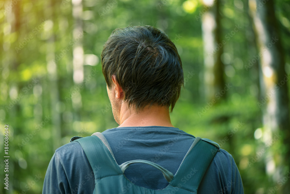 Man with backpack enjoying walk in the park Man with backpack enjoying walk in the park