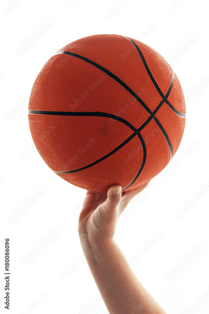 Female hand with basketball ball isolated on white background Female hand with basketball ball isolated on white background