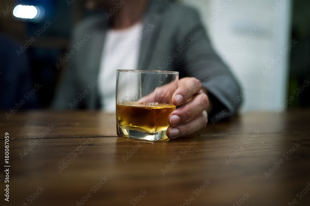 Shot of a person carrying a glass of alcohol