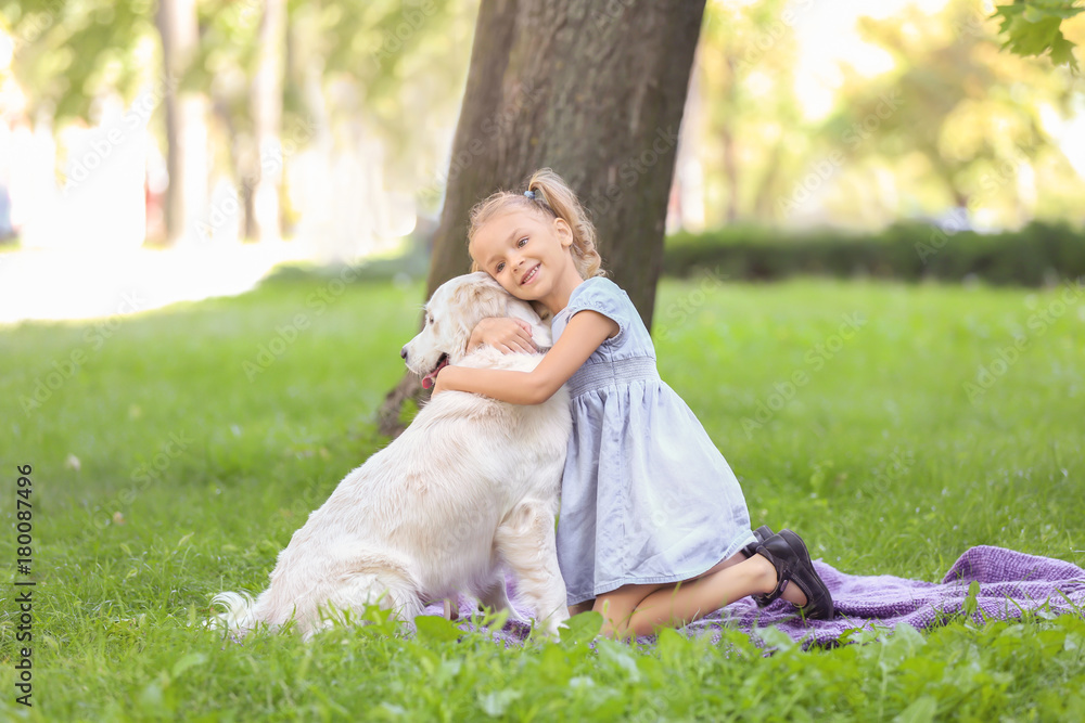 Fototapeta premium Cute little girl with dog in park