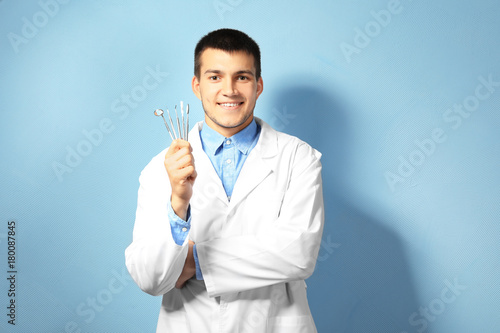 Young male dentist with too...