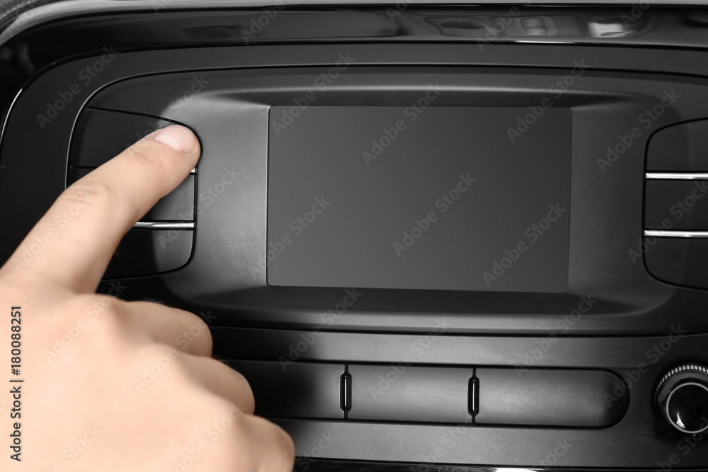Man tuning radio in car Man tuning radio in car