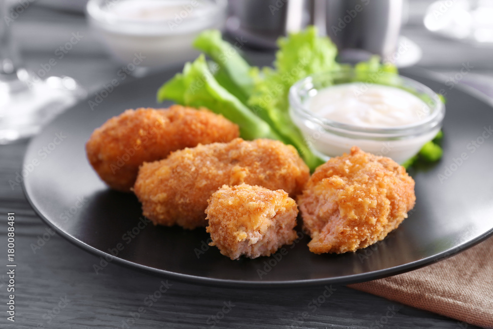Plate with tasty salmon croquettes on table Plate with tasty salmon croquettes on table