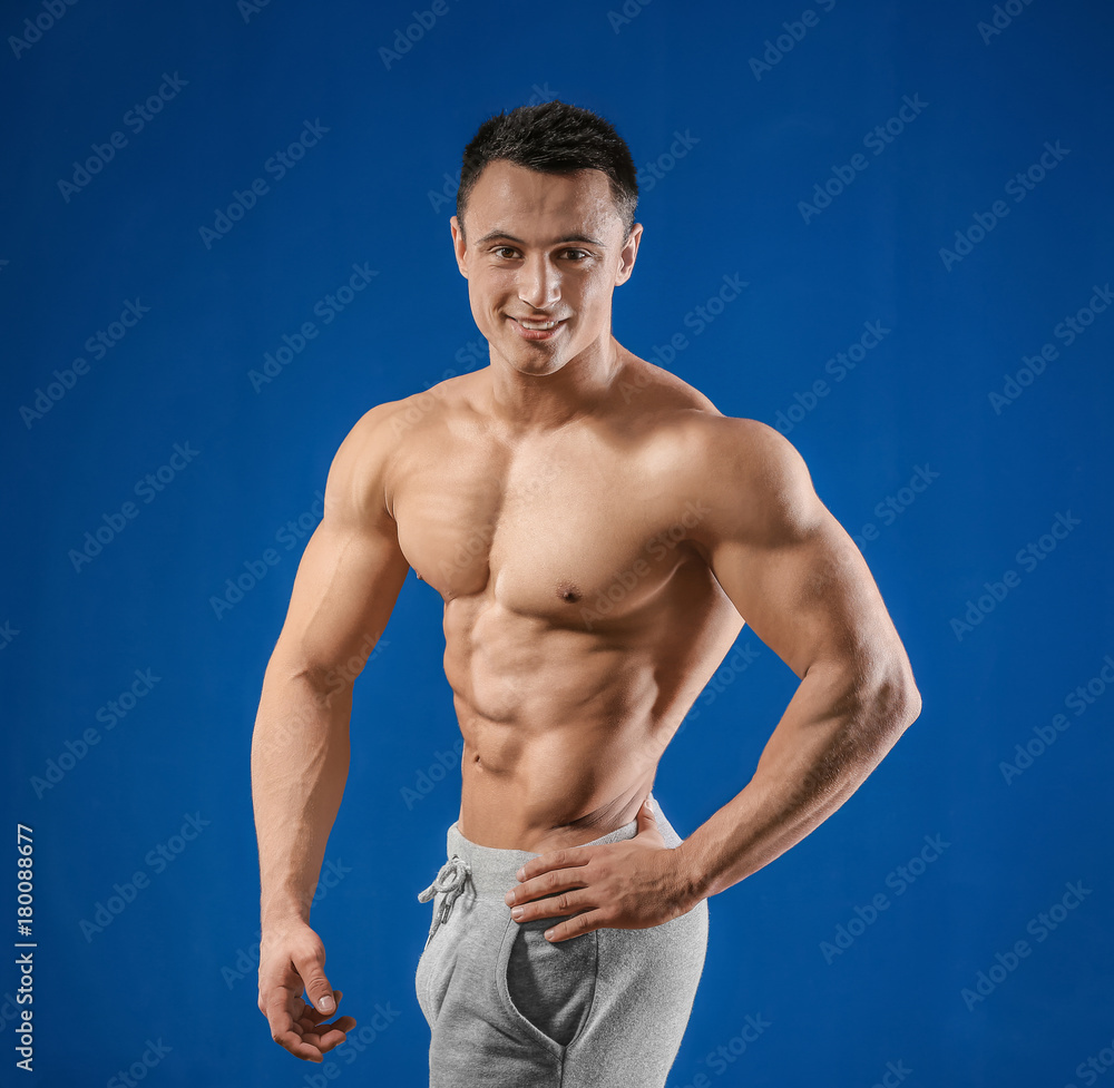 Muscular young man on color background Muscular young man on color background