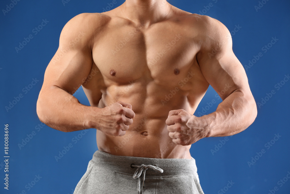 Fototapeta premium Muscular young man on color background