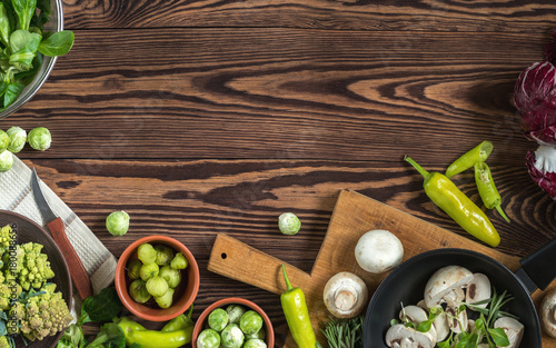 Variety of organic fresh vegetables on wooden background