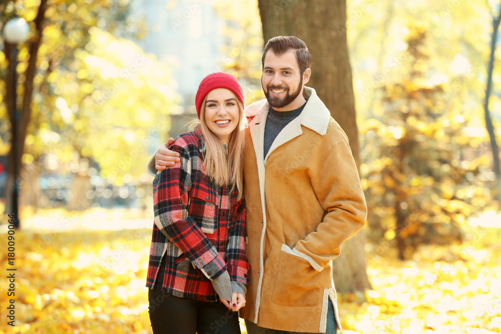Young couple in park on autumn day Young couple in park on autumn day