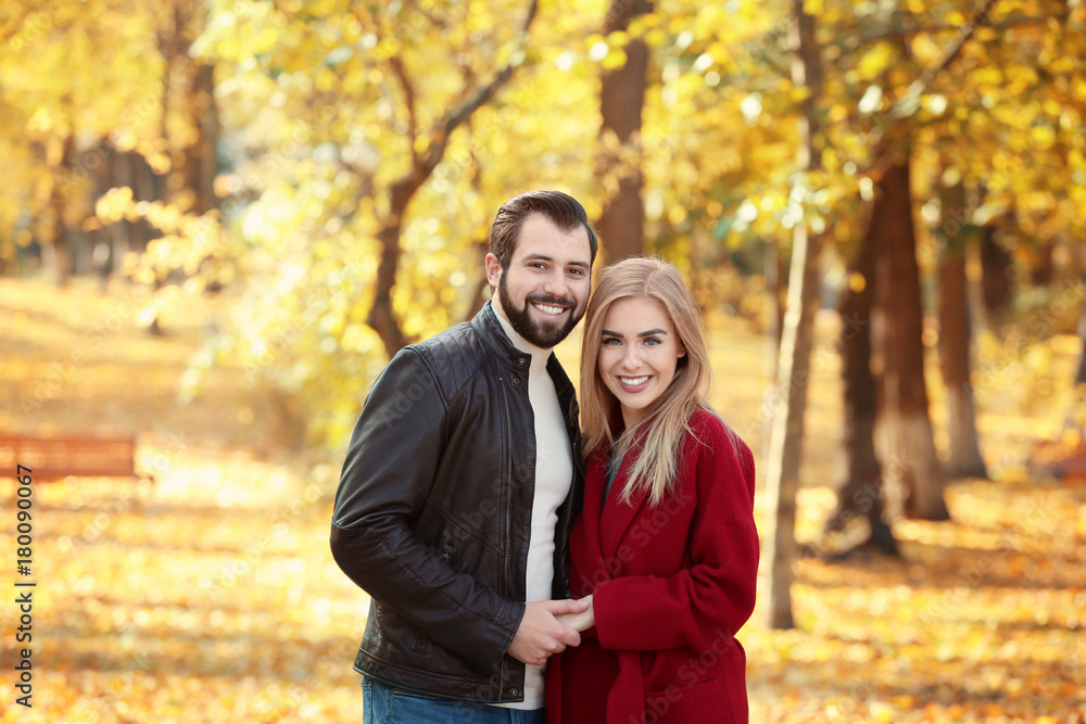 Young couple in park on autumn day