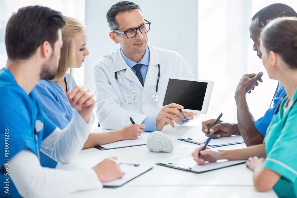 doctors having conversation and looking at tablet doctors having conversation and looking at tablet