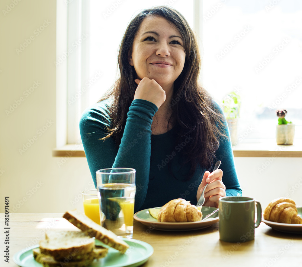 Cheerful woman smiling while eating Cheerful woman smiling while eating