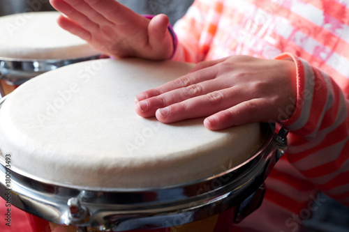 Children's hands on the drum
