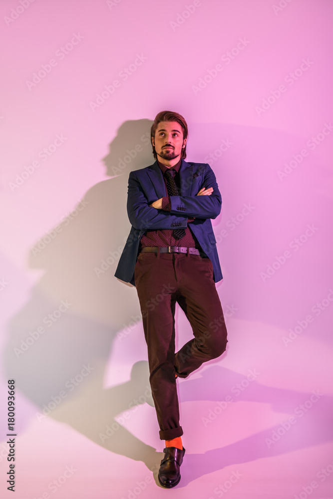 stylish man posing at pink wall stylish man posing at pink wall