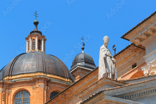 Urbino, Italy - August 9, 2017: The Cathedral. Piazza Duca Federico. Sculpture and statue in architecture. © makam1969