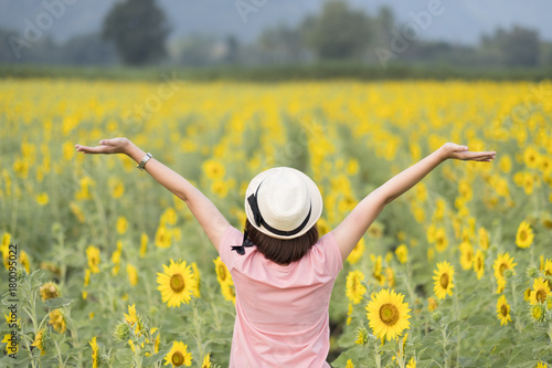 Happy girl in sunflower field photo