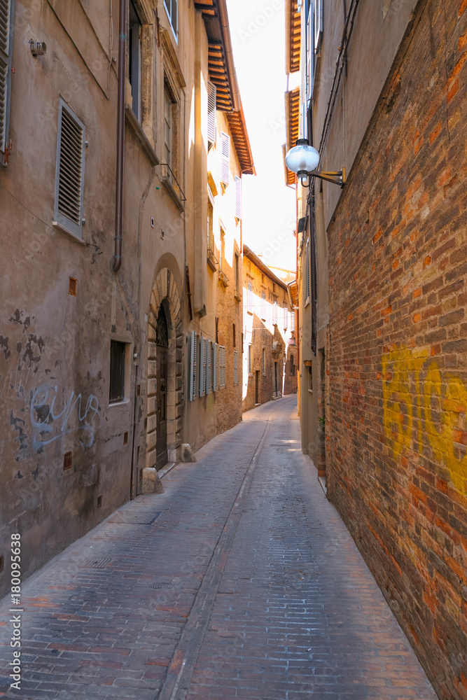 Urbino, Italy - August 9, 2017: A small street in the old town of Urbino. sunny day.