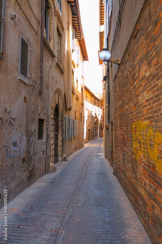 Urbino, Italy - August 9, 2017: A small street in the old town of Urbino. sunny day. © makam1969