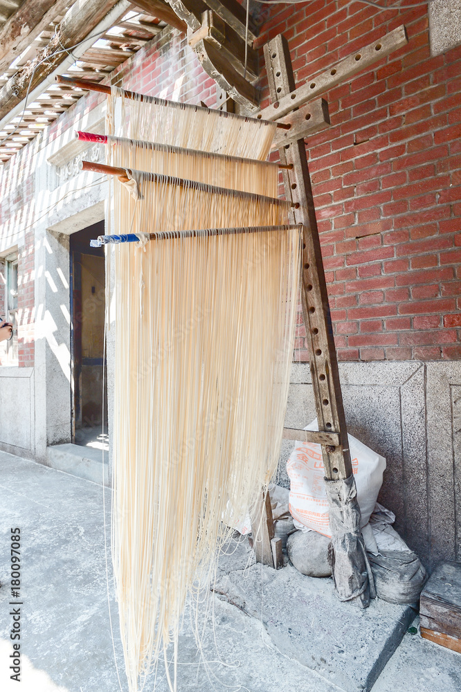 Obraz premium Changhua Lukang Fuxing handmade noodles - October 22 ,2017:The traditional way to dry fine flour in Taiwan, hanging chinese noodles.