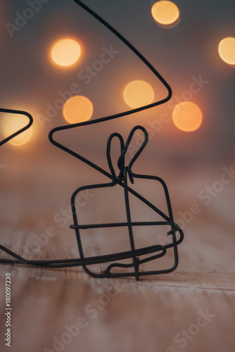 Fototapeta Naklejka Na Ścianę i Meble -  Christmas gift made of wire with Christmas light-warm colors