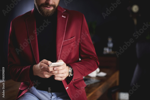 Unrecognizable businessman using smartphone in office
