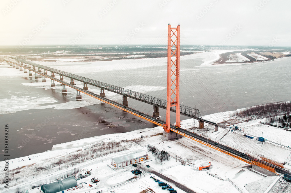 Fototapeta premium High road bridge over the river and railway bridge. view of the freezing river with ice.