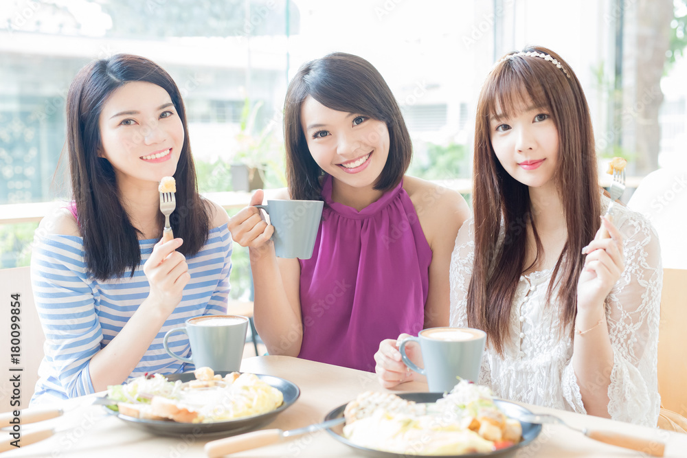 happy woman friends in restaurant