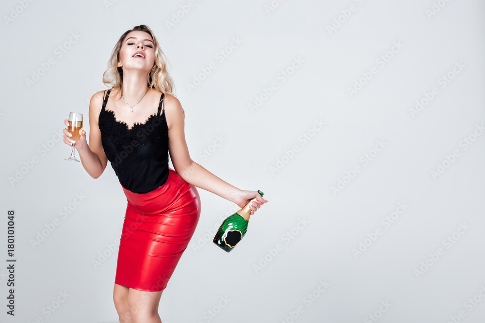 woman holding glass of champagne and bottle woman holding glass of champagne and bottle