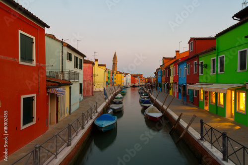 Colorful houses and boats at evening in Burano, Venice Italy. © Shchipkova Elena