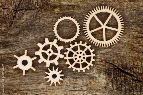 Wooden gears on wooden background