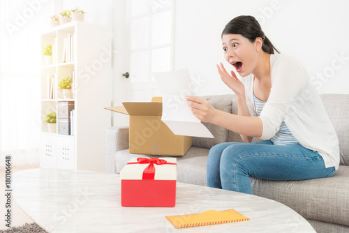 happy shocked lady unpacking personal parcel box © PR Image Factory