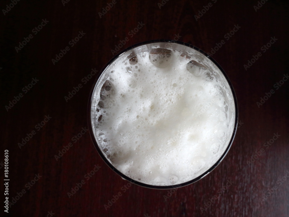 beer foam in a glass top view on a dark background beer foam in a glass top view on a dark background