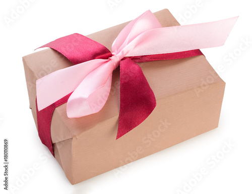 Wrapped gift box with two colors red and pink ribbon bow, isolated on a white background, close up, top view.