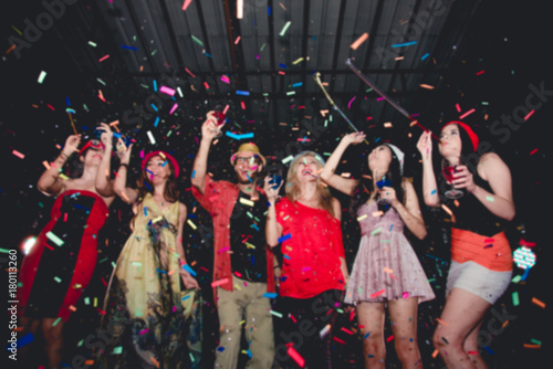 Blurred People in Party - Group of Friends Enjoy Throwing Confetti and Dancing in Nightclub
