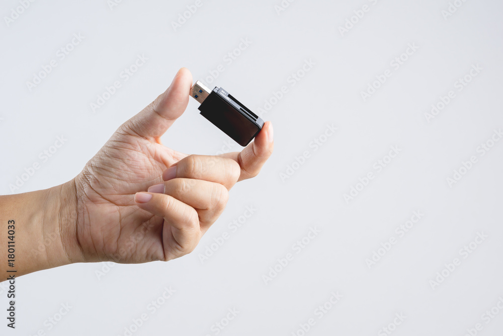 Hand holding black USB memory or storage card reader stick Hand holding black USB memory or storage card reader stick
