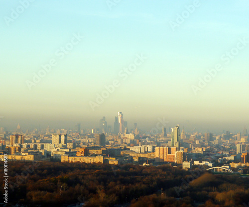 Skyscrapers on smog in industrial town from a great distance © yuakimov