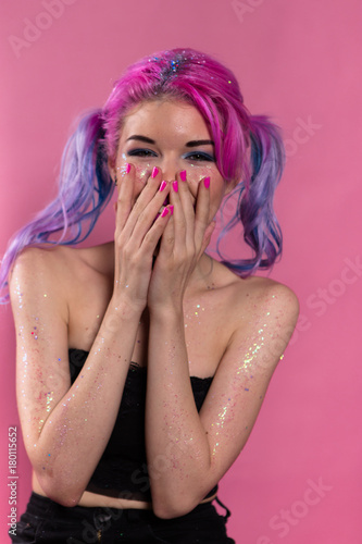 Canvas-taulu Young woman heavily madeup laughing and covering her mouth by arms