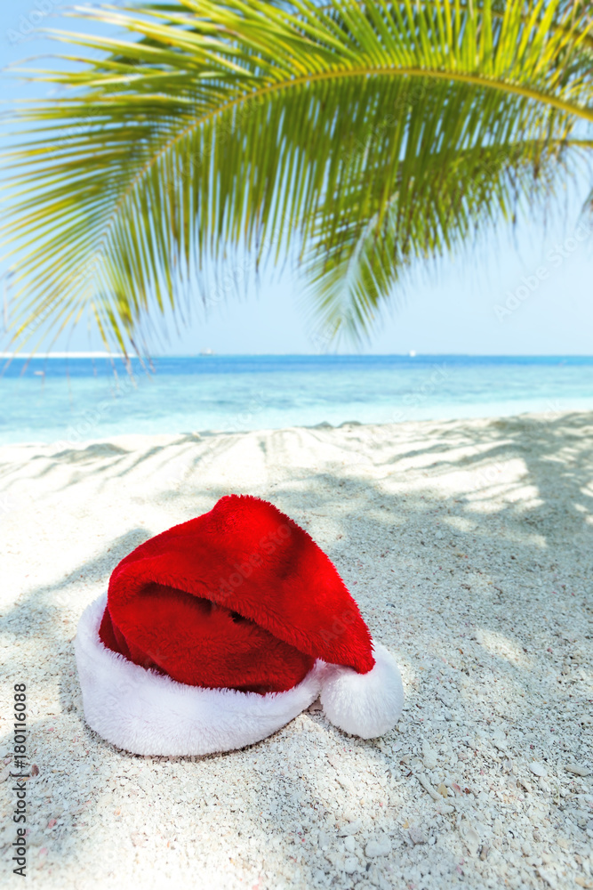 Santa Claus hat on perfect tropical beach Santa Claus hat on perfect tropical beach