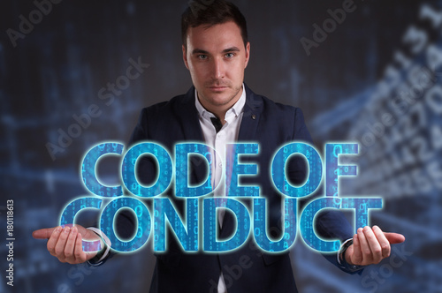 The concept of business, technology, the Internet and the network. Young businessman showing inscription: Code of conduct