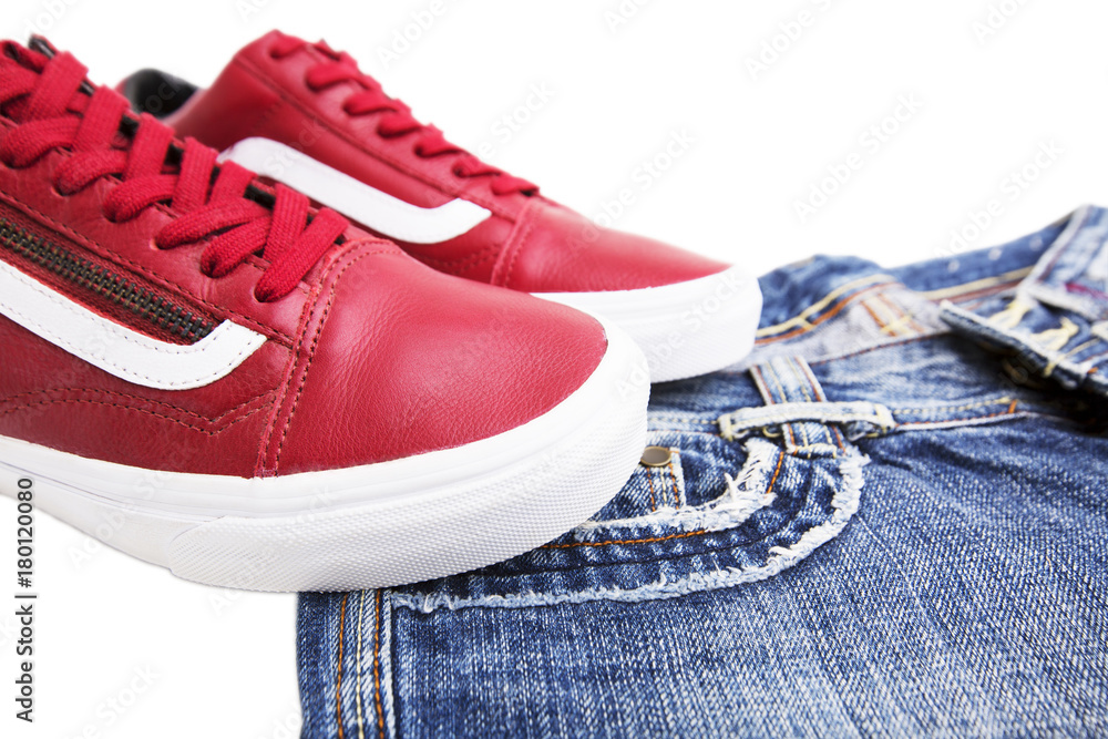 Fashion shoes with shoes. Red sneakers and laces with jeans on a white background Fashion shoes with shoes. Red sneakers and laces with jeans on a white background