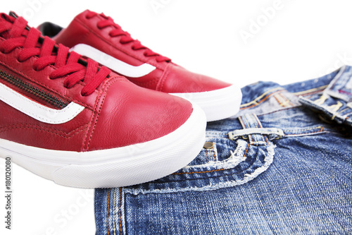 Fashion shoes with shoes. Red sneakers and laces with jeans on a white background