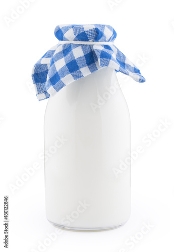 Old fasioned glass bottle of milk isolated on white background photo