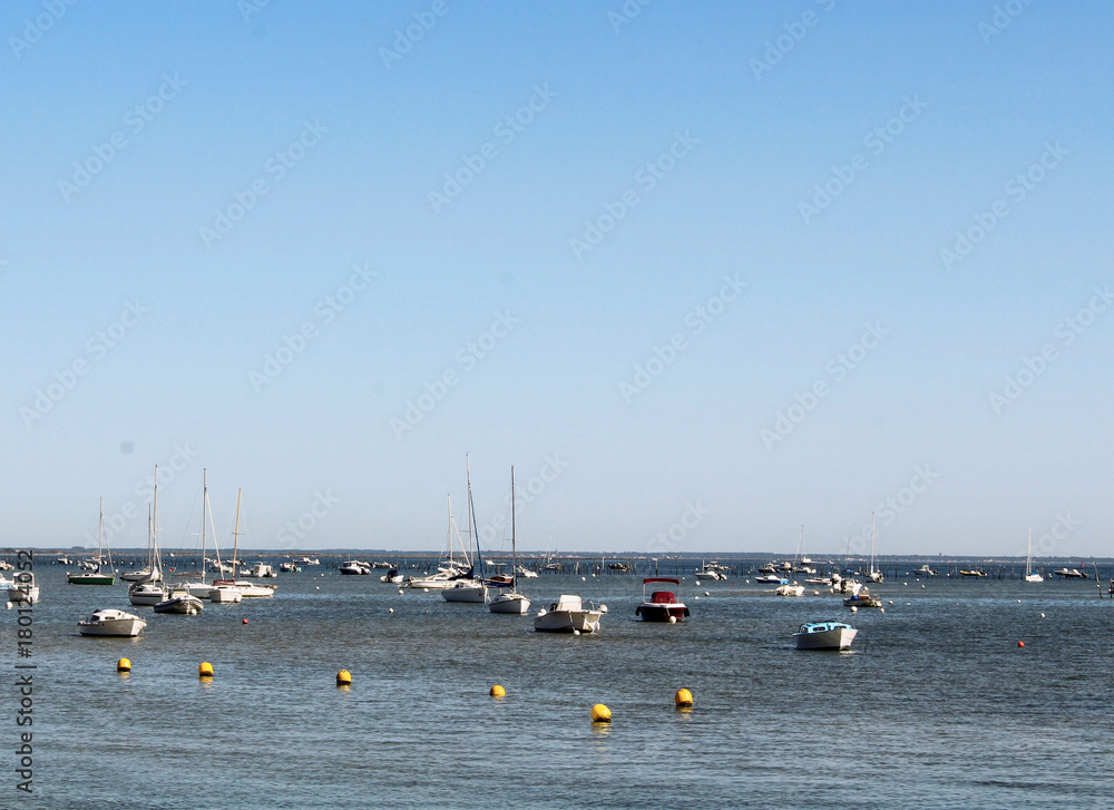 a sand beach with a lot boats on the sea in France