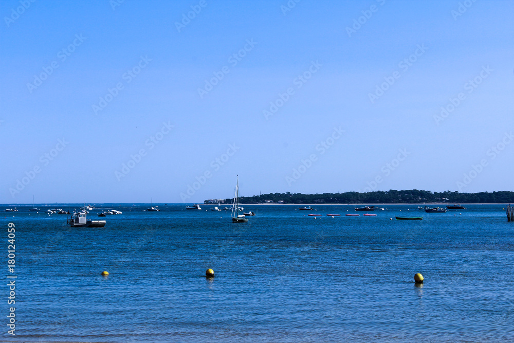 a sand beach with a lot boats on the sea in France