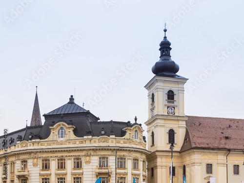 Fragment of the Roman Catholic Church of the Holy Trinity and Sibiu City Hall on the Large Square in Sibiu city in Romania