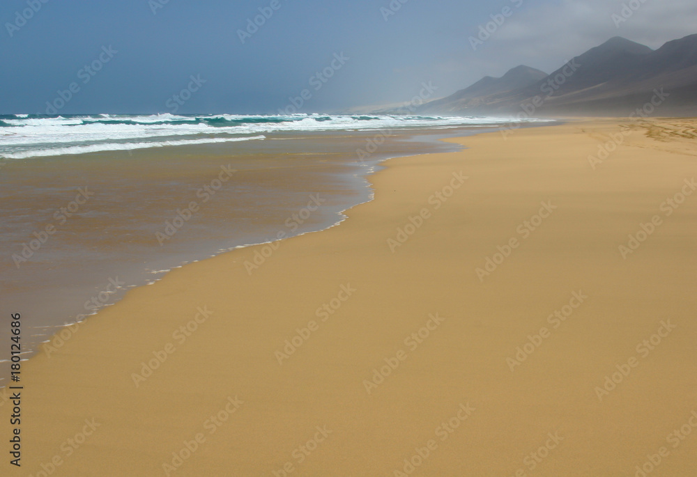 Ocean surf on magnificent Cofete beach in secluded part of Fuerteventura, Canary Islands, Spain