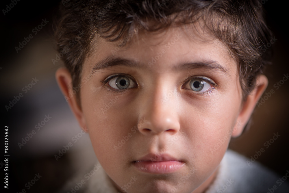 Close viewing portrait of cute young boy with expressive eyes Close viewing portrait of cute young boy with expressive eyes