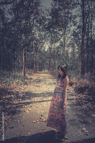 Close up sad beautiful asian woman from unrequire love in the forest,she think so much about boyfriend,life without love,vintage dark style photo