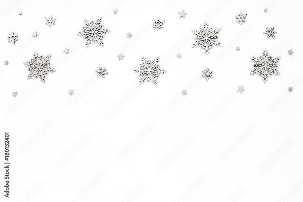 Silver christmas snowflake on white background, flat lay, top view, christmas pattern Silver christmas snowflake on white background, flat lay, top view, christmas pattern