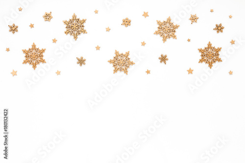 Golden christmas snowflake on white background, flat lay, top view, christmas pattern