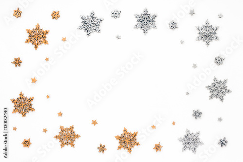 Golden and silver christmas snowflake on white background, flat lay, top view, christmas frame