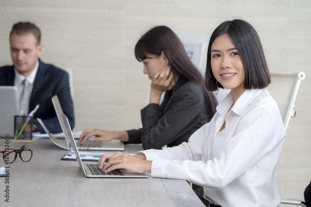 Fototapeta premium Asian Woman have a meeting with team for Business present. Woman working at meeting room with team. People working concept. 20-30 years old.